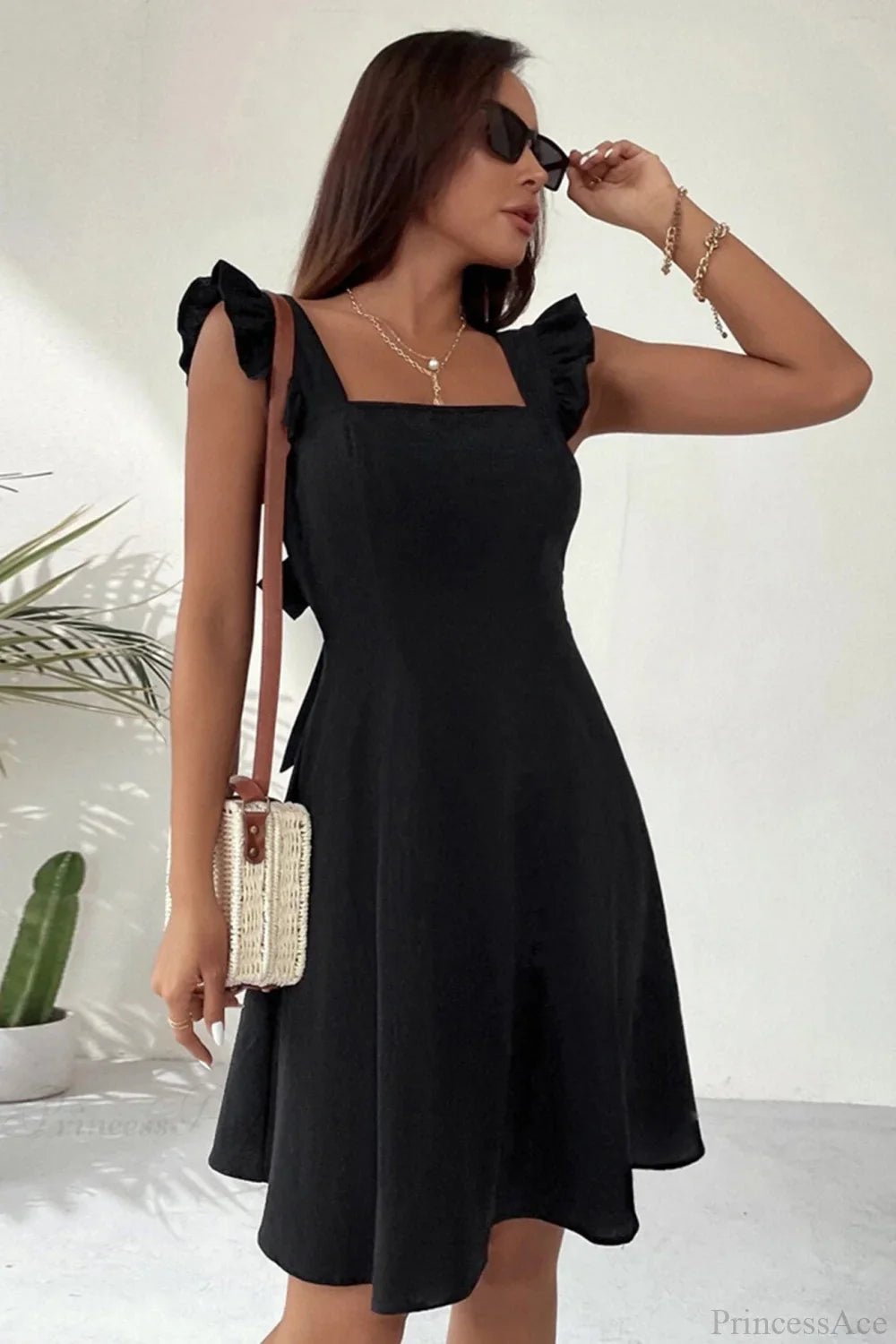 Minivestido sin mangas Nora con volante y lazo trasero