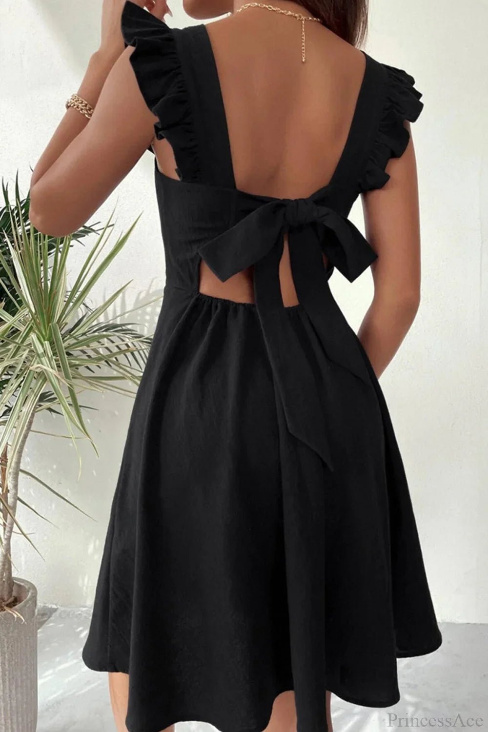 Minivestido sin mangas Nora con volante y lazo trasero